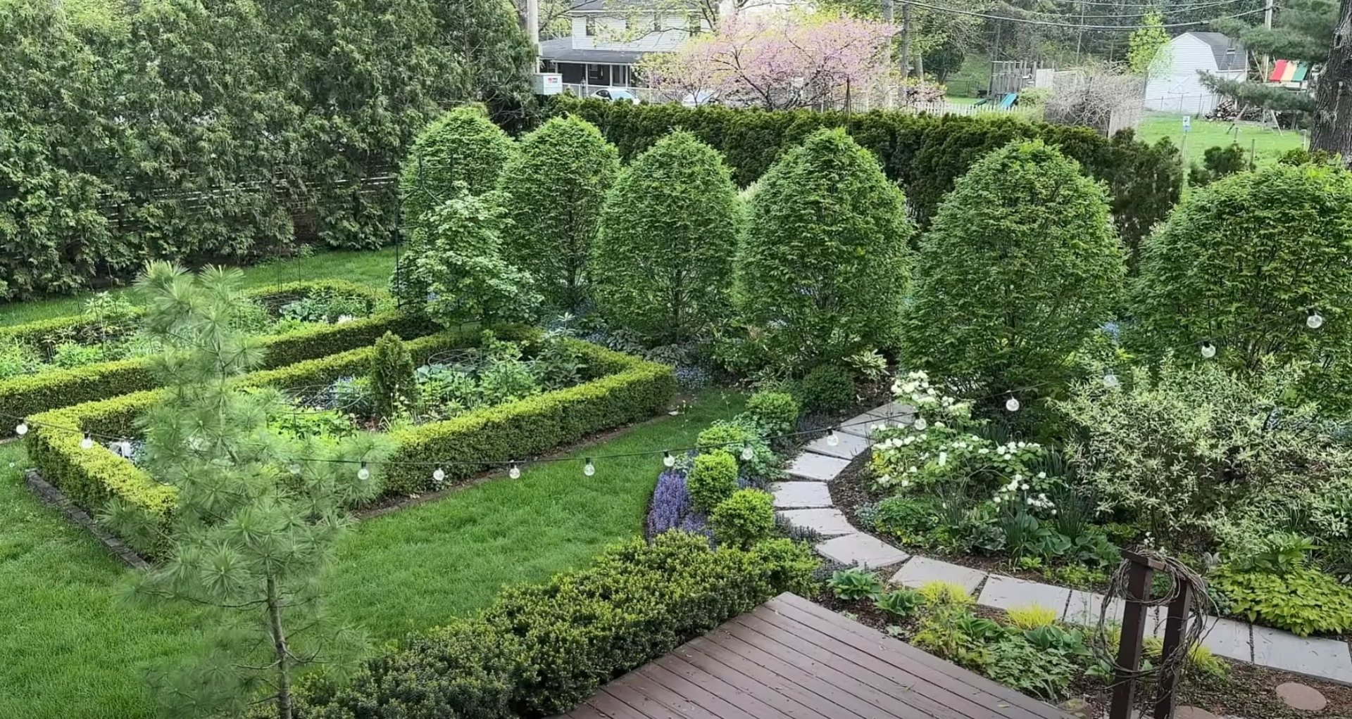Formal Landscape Design - Geometric Lawn Installation and Garden Borders Formal garden landscape with geometric lawn patterns, hedged borders, and professional hardscaping elements
